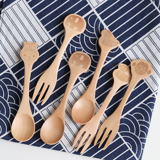 Cartoon wooden spoon and fork set for kids by WoodyKitchenware, colorful playful utensils for children’s dining.