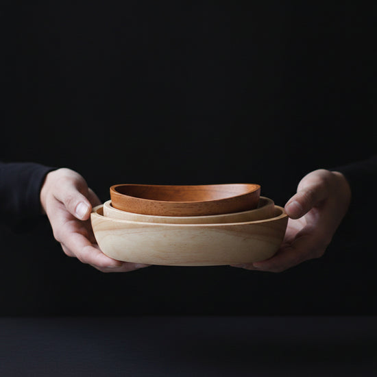 Large oval wooden bowl with minimalist boat curve design by WoodyKitchenware, crafted from solid timber for serving and decor.