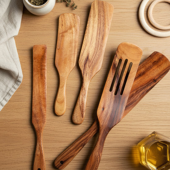 Set of WoodyKitchenware acacia long-handled spatulas with wooden handles for mixing and cooking, displayed on a kitchen countertop.