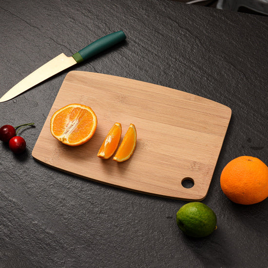 WoodyKitchenware bamboo cutting board for kitchen organization, showing a sleek, rectangular bamboo surface with natural grain.