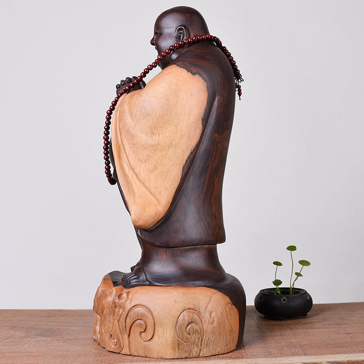 Ebony wooden Buddha statue, 30cm tall, depicting a laughing guardian figure by WoodyKitchenware, crafted from solid timber.