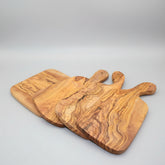 Irregular solid olive wood cutting board by WoodyKitchenware, Mediterranean Shield design, natural wood grain, 30x15cm kitchen accessory.