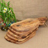Irregular solid olive wood cutting board by WoodyKitchenware, featuring natural Mediterranean shield design and smooth finish.