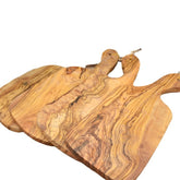 Olive wood cutting board by WoodyKitchenware with irregular edges, perfect for kitchen prep and serving.
