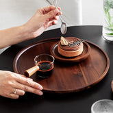 Wooden circular Japanese storage cake tray and stand by WoodyKitchenware, featuring a smooth round wooden surface with elegant craftsmanship.