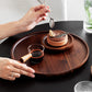 Wooden circular Japanese storage cake tray and stand by WoodyKitchenware, featuring a smooth round wooden surface with elegant craftsmanship.