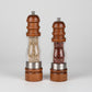 Wooden salt and pepper grinder duo by WoodyKitchenware with solid timber design, placed on a kitchen countertop.