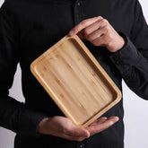 Rectangular bamboo wooden dinner tray by WoodyKitchenware, showing a natural finish and sturdy handles for household use.