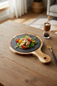 Black wood pizza dish from WoodyKitchenware, a wooden plate ideal for serving pizza with stylish rustic appeal.