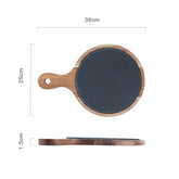 Black wooden pizza dish from WoodyKitchenware, stylish serving plate for pizzas, crafted from natural wood with a sleek finish.