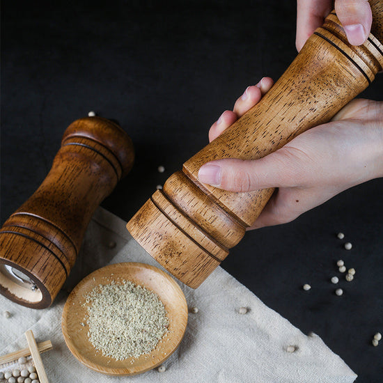 Manual wooden spice grinder by WoodyKitchenware with a handcrafted ceramic mill and rustic wooden handle.