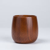 Hand-carved wooden kuksa mug from WoodyKitchenware, featuring intricate artisan craftsmanship and natural wood finish.