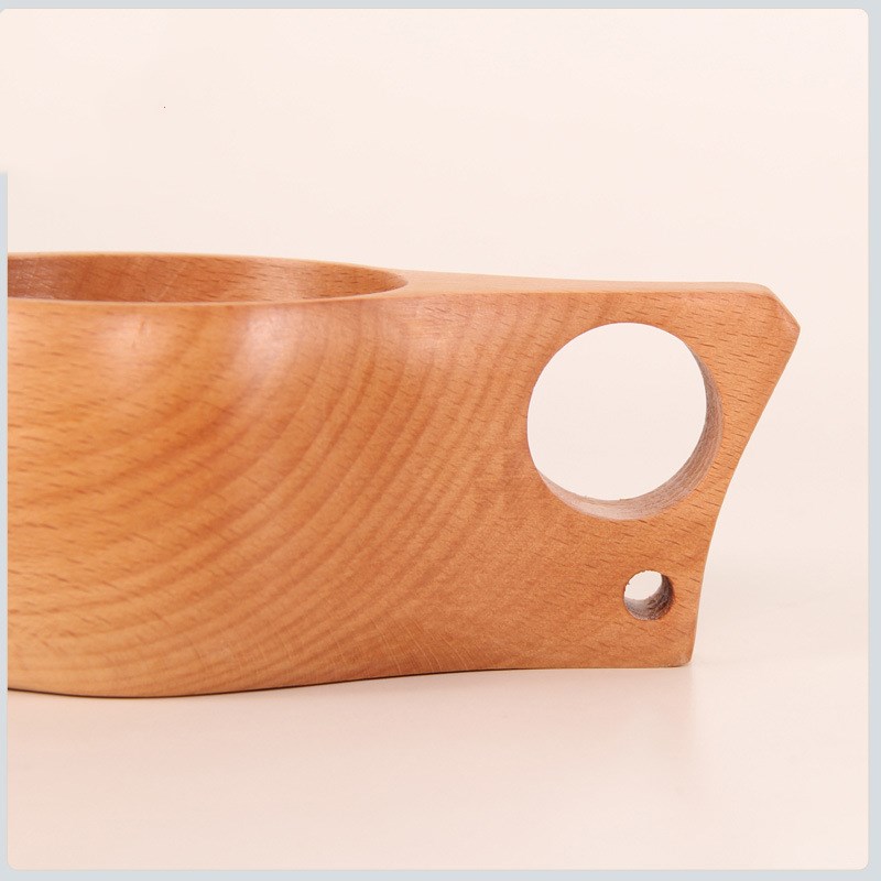 Hand-carved beechwood Kuksa cup by WoodyKitchenware, featuring a single-hole design and rustic wood texture.
