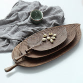 Small handmade wooden tray by WoodyKitchenware, featuring a glossy beech wood finish and forest sculpture design.