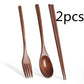 Black wooden long handle spoon and chopsticks set from WoodyKitchenware, portable tableware for travel and dining.
