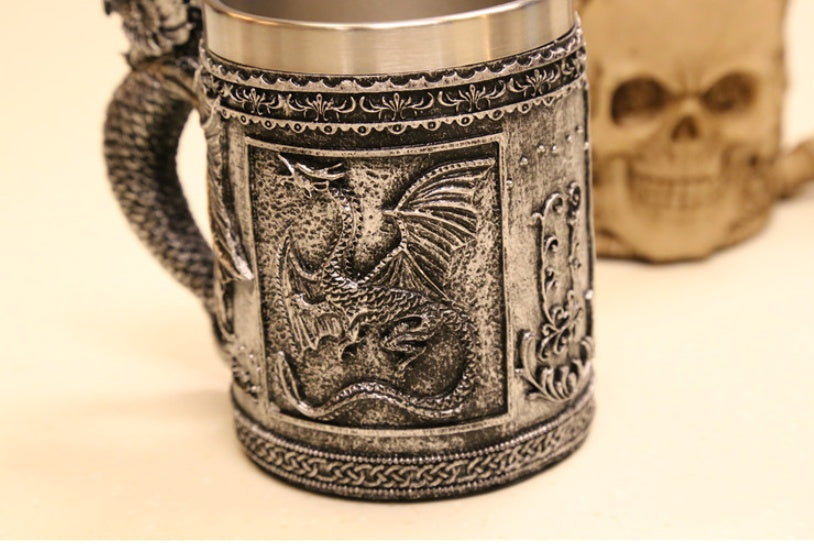 Sculpted silver dragon relic from WoodyKitchenware called The Drake's Talon, featuring detailed dragon design on a black background.