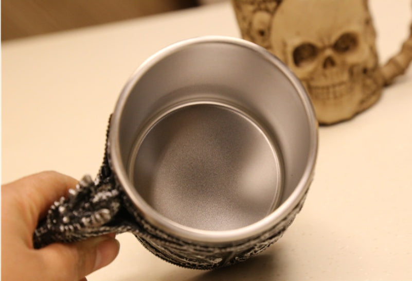 Sculpted silver dragon relic called The Drake's Talon by WoodyKitchenware displayed on a black background.