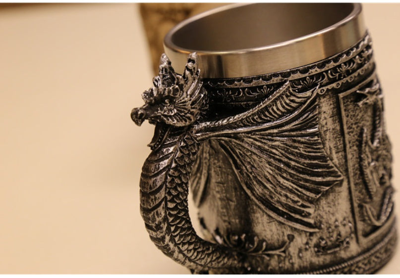 Sculpted silver dragon relic called The Drake's Talon by WoodyKitchenware, featuring detailed dragon design on a black background.