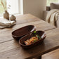 Brown acacia wooden canoe from WoodyKitchenware, crafted by WoodyKitchenware, showcasing natural wood grain and unique canoe shape.