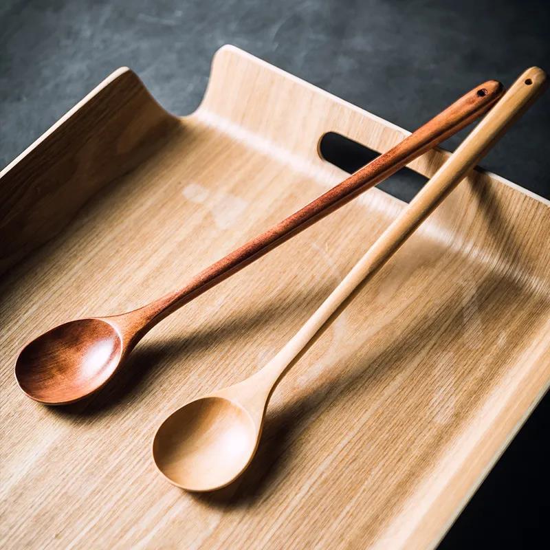 Brown extra-long wooden cooking spoon by WoodyKitchenware, ideal for stirring deep pots and cooking.