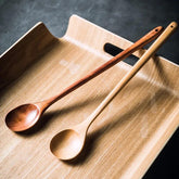 Brown extra-long wooden cooking spoon by WoodyKitchenware, ideal for stirring deep pots and cooking.