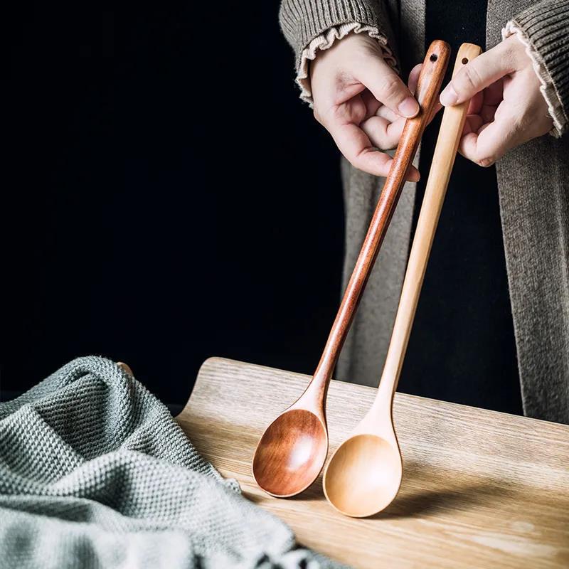 Extra-long wooden cooking spoon by WoodyKitchenware, ideal for stirring deep pots and cooking with natural wood handle.