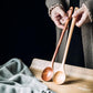 Extra-long wooden cooking spoon by WoodyKitchenware, ideal for stirring deep pots and cooking with natural wood handle.