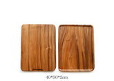 Rectangular wooden plate made of acacia wood by WoodyKitchenware, perfect for serving appetizers or snacks in a stylish dining setting.