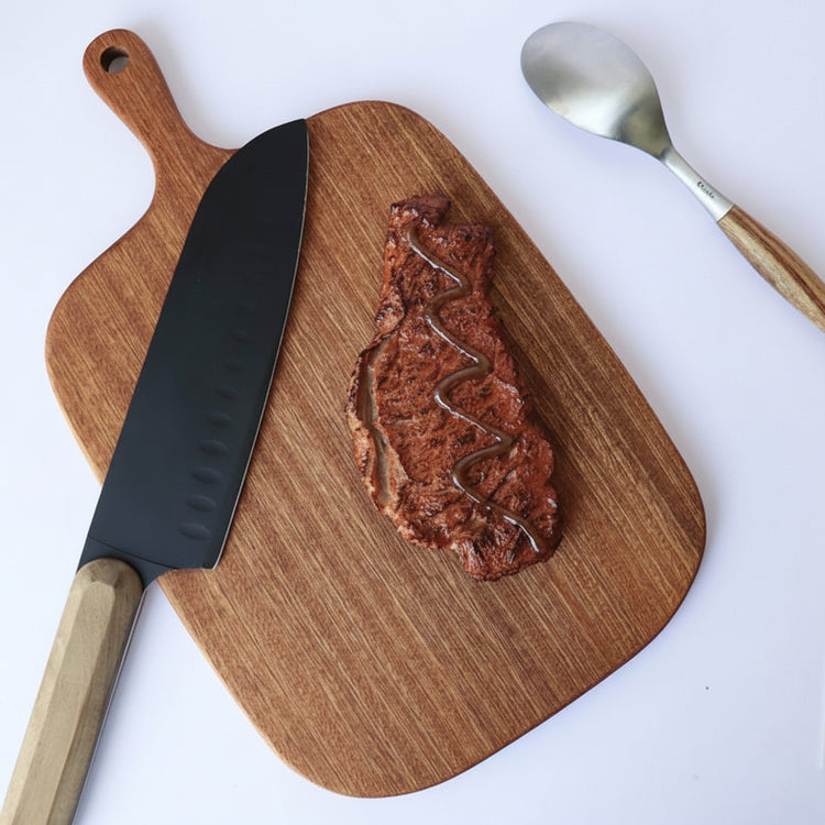 Solid wood vegetable cutting board by WoodyKitchenware, durable and eco-friendly kitchen essential with a large handle.