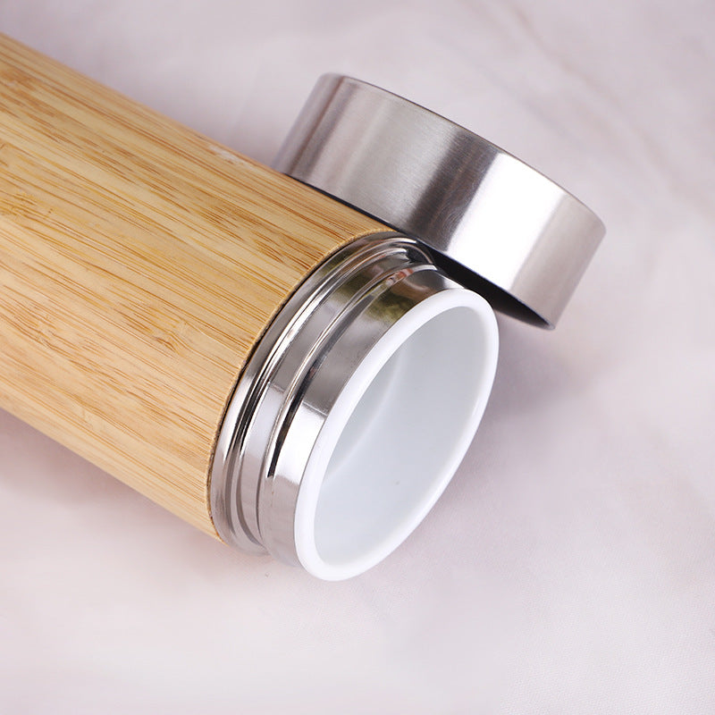 Hand-finished bamboo and steel vessel from WoodyKitchenware, used for infusing teas or herbs, with a sleek, modern design.