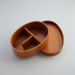 Round brown wooden bento box by WoodyKitchenware, traditional Japanese lunch box with smooth wood finish and compact design.