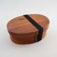Round brown wooden bento box by WoodyKitchenware, traditional Japanese lunch box with smooth finish and wooden lid.