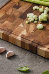 Dark brown Acacia Mangium thick cutting board by WoodyKitchenware, durable and stylish kitchen essential with wood grain texture.