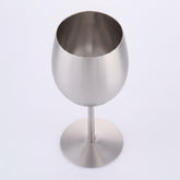 Artisan stainless steel chalice called The Sovereign Stem by WoodyKitchenware, featuring a sleek, polished design on a plain background.