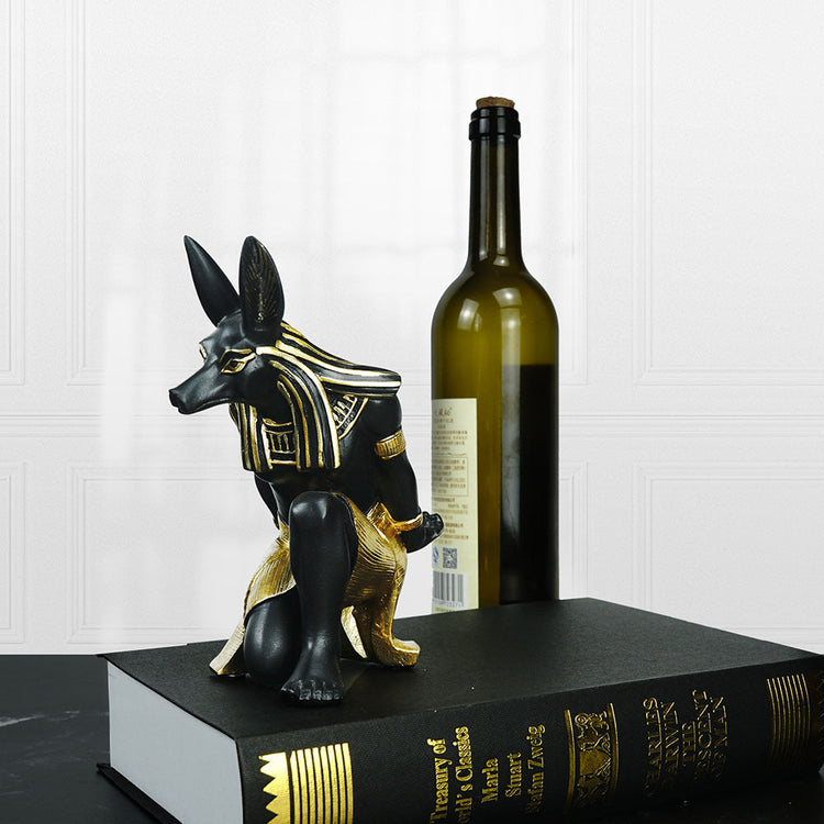 Resin Anubis Dog-God wine rack ornament by WoodyKitchenware, depicting a mystical Anubis figure holding a wine bottle in its paws.
