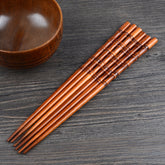 Pair of fired bamboo chopsticks by WoodyKitchenware, eco-friendly and durable dining utensils from WoodyKitchenware.