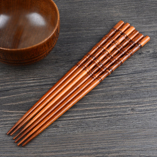 Pair of fired bamboo chopsticks by WoodyKitchenware, eco-friendly and durable dining utensils from WoodyKitchenware.