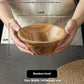 Wooden dough bowl by WoodyKitchenware featuring solid timber construction and a 25cm bamboo basin for baking and mixing.