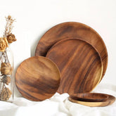 Unfinished acacia solid wood round plates by WoodyKitchenware, natural wooden dishware with a smooth, raw wood finish.