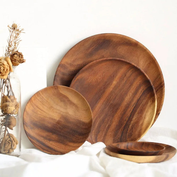 Unfinished acacia solid wood round plates by WoodyKitchenware, natural wooden dishware with a smooth, raw wood finish.