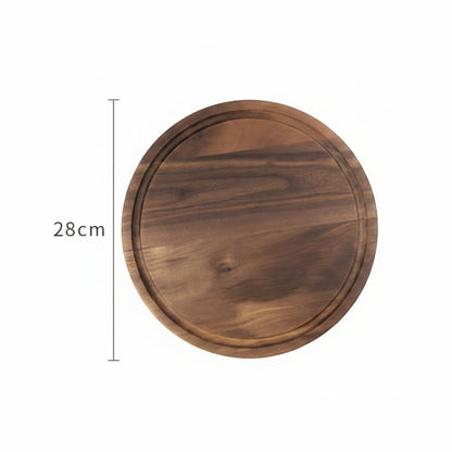 Round black walnut wood cutting board by WoodyKitchenware, used as a creative kitchen tray for food prep and serving.
