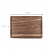 Round black walnut wood cutting board by WoodyKitchenware, showcasing a smooth, natural finish ideal for kitchen prep and serving.