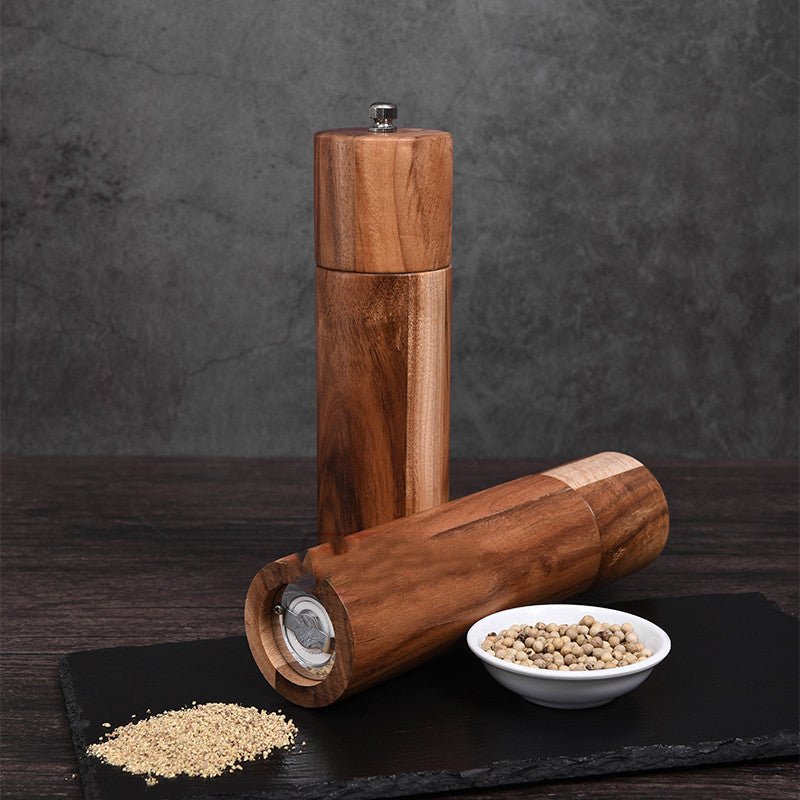 Cylindrical acacia wood pepper grinder with ceramic core by WoodyKitchenware, sleek and reliable kitchen spice grinder.