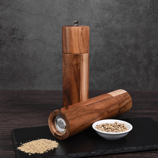 Cylindrical acacia wood pepper grinder with ceramic core by WoodyKitchenware, sleek and reliable kitchen spice grinder.
