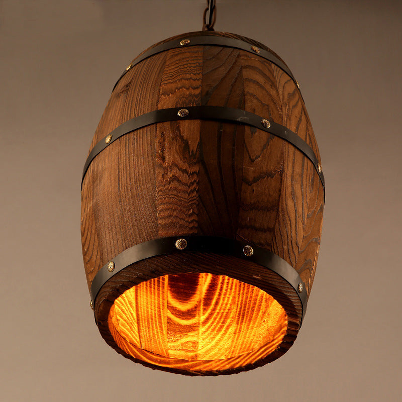 Rustic wooden wine barrel chandelier with vintage design, hanging in a cozy dining or living space, featuring exposed bulbs.