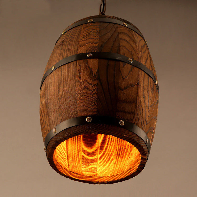 Rustic wooden wine barrel chandelier with vintage design, hanging in a cozy dining or living space, featuring exposed bulbs.