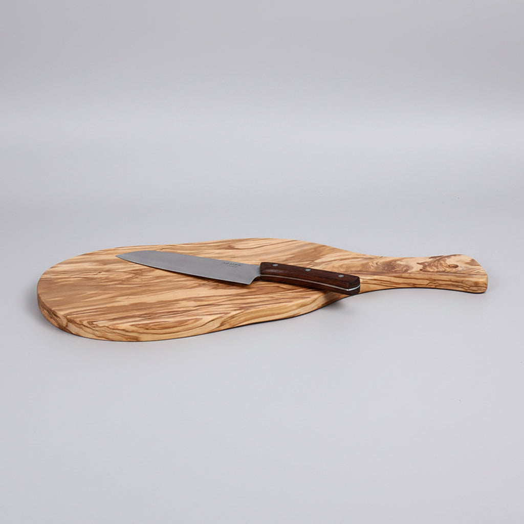 Olive wood cutting board from WoodyKitchenware with natural wood grain, ideal for food prep and serving in Mediterranean style.