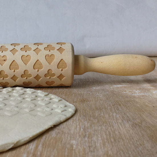 Wooden Christmas poker printing rolling pin with festive holiday patterns, perfect for adding seasonal charm to baked goods.