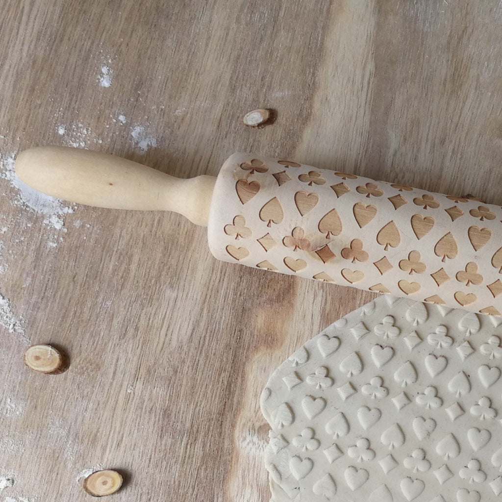 Wooden Christmas poker printing rolling pin with festive holiday designs, perfect for adding seasonal fun to baking.