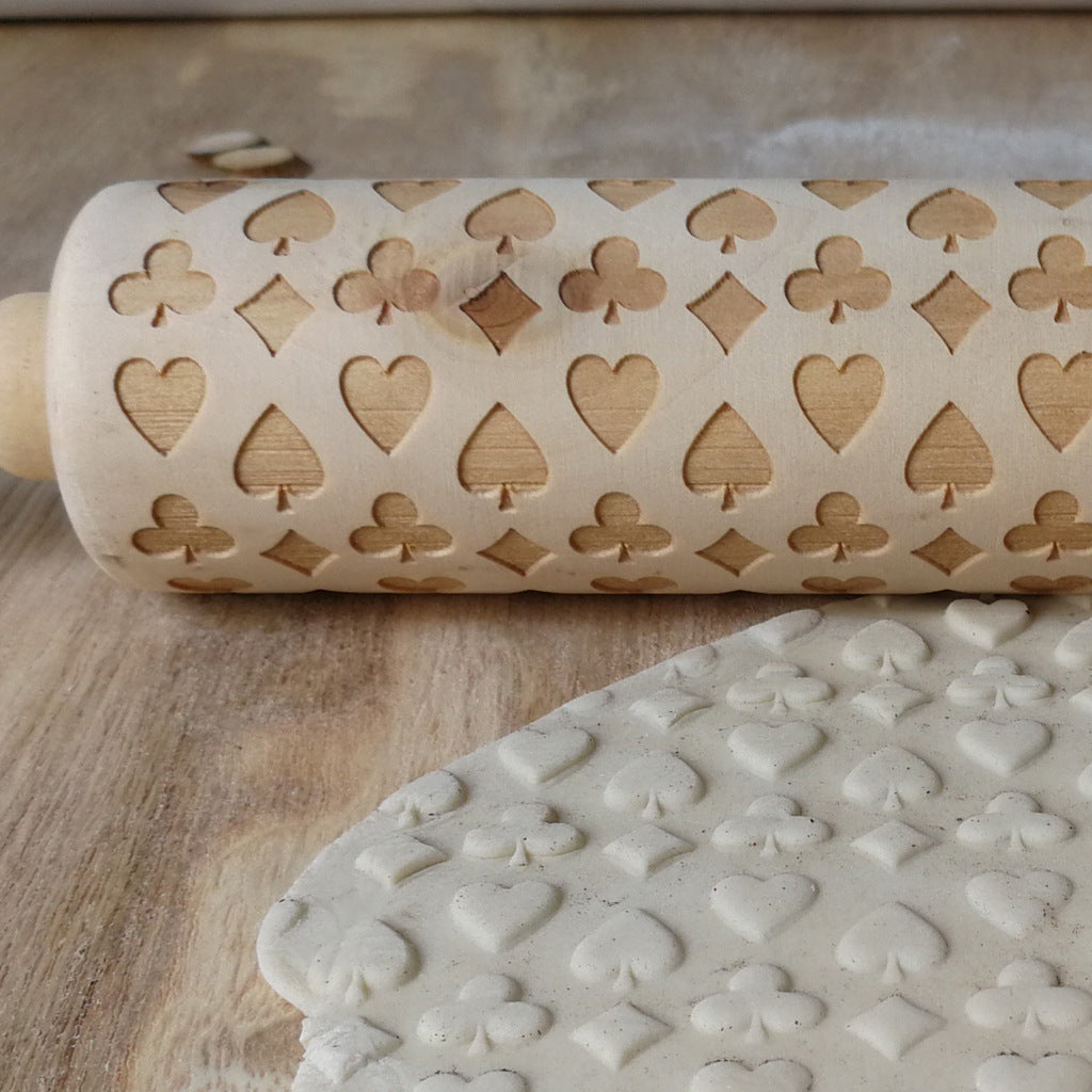 Wooden Christmas poker printing rolling pin with festive holiday patterns, ideal for baking and adding holiday charm to cookies.